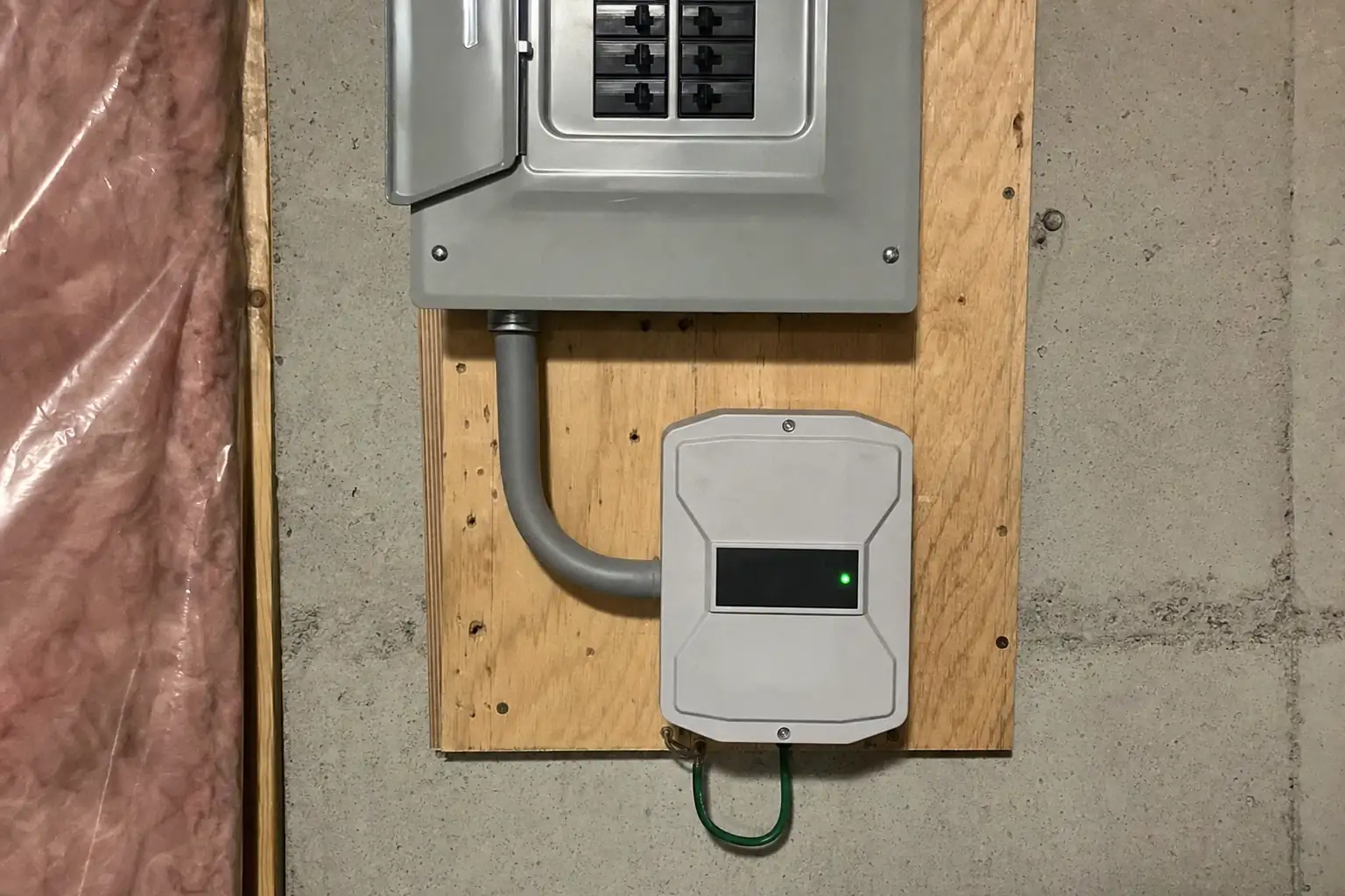 Type 2 whole-home surge protector with green status lights wired to a double-pole breaker