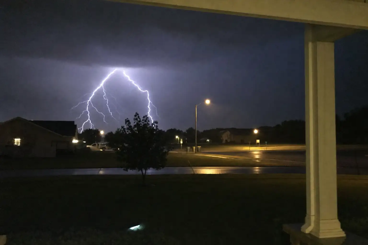 Lightning storm over a suburban street at night